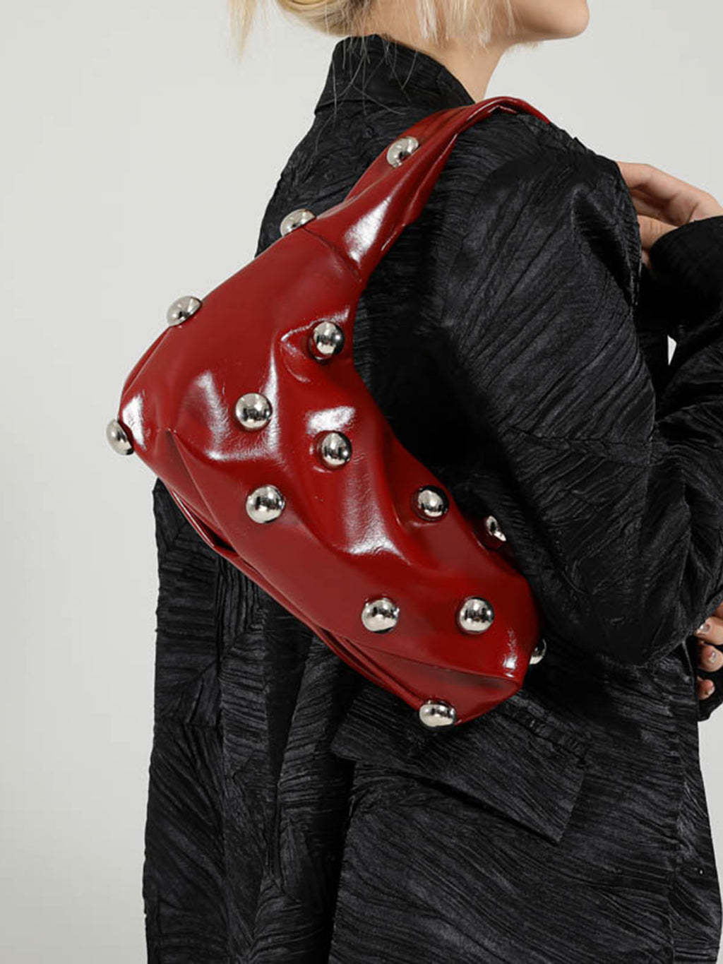 Bolso femenino de hombro con detalles metálicos decorativos